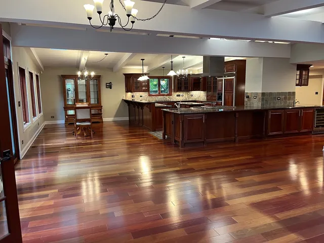 a kitchen with stainless steel appliances granite countertop stove top oven and cabinets