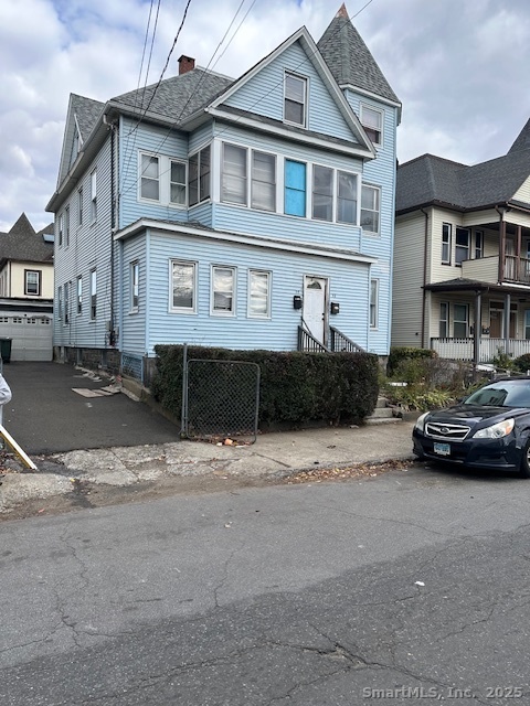 54 James Street, Unit 1 Bridgeport, CT 06604 - Photo 1 of 8 a car parked in front of a white house