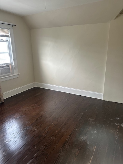 54 James Street, Unit 1 Bridgeport, CT 06604 - Photo 2 of 8 an empty room with wooden floor and windows in it