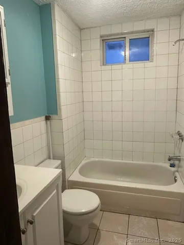 a bathroom with a bathtub and a toilet