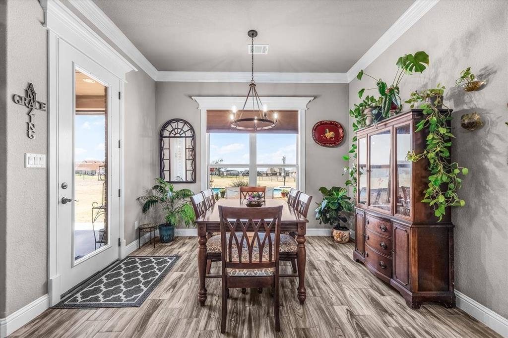 139 Stanford Lane Springtown, TX 76082 - Photo 14 of 36 Dining area featuring natural light, crown molding, and decorative lights