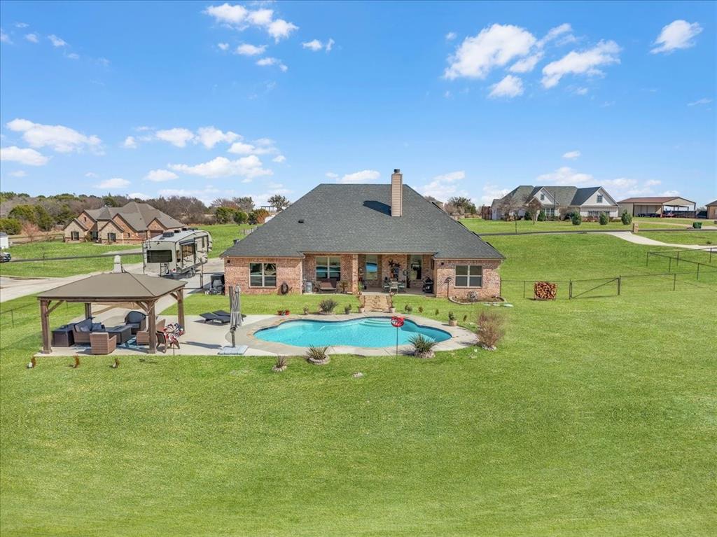 139 Stanford Lane Springtown, TX 76082 - Photo 2 of 36 Rear view of property featuring pool, gazebo and fenced backyard