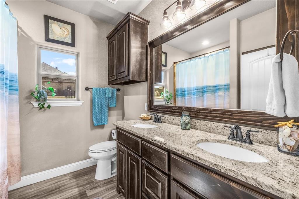 139 Stanford Lane Springtown, TX 76082 - Photo 22 of 36 Bathroom featuring double vanity, a bathtub/ shower combination
