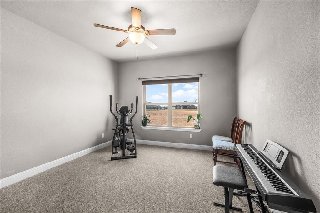 139 Stanford Lane Springtown, TX 76082 - Photo 23 of 36 Bedroom with ceiling fan and new carpet