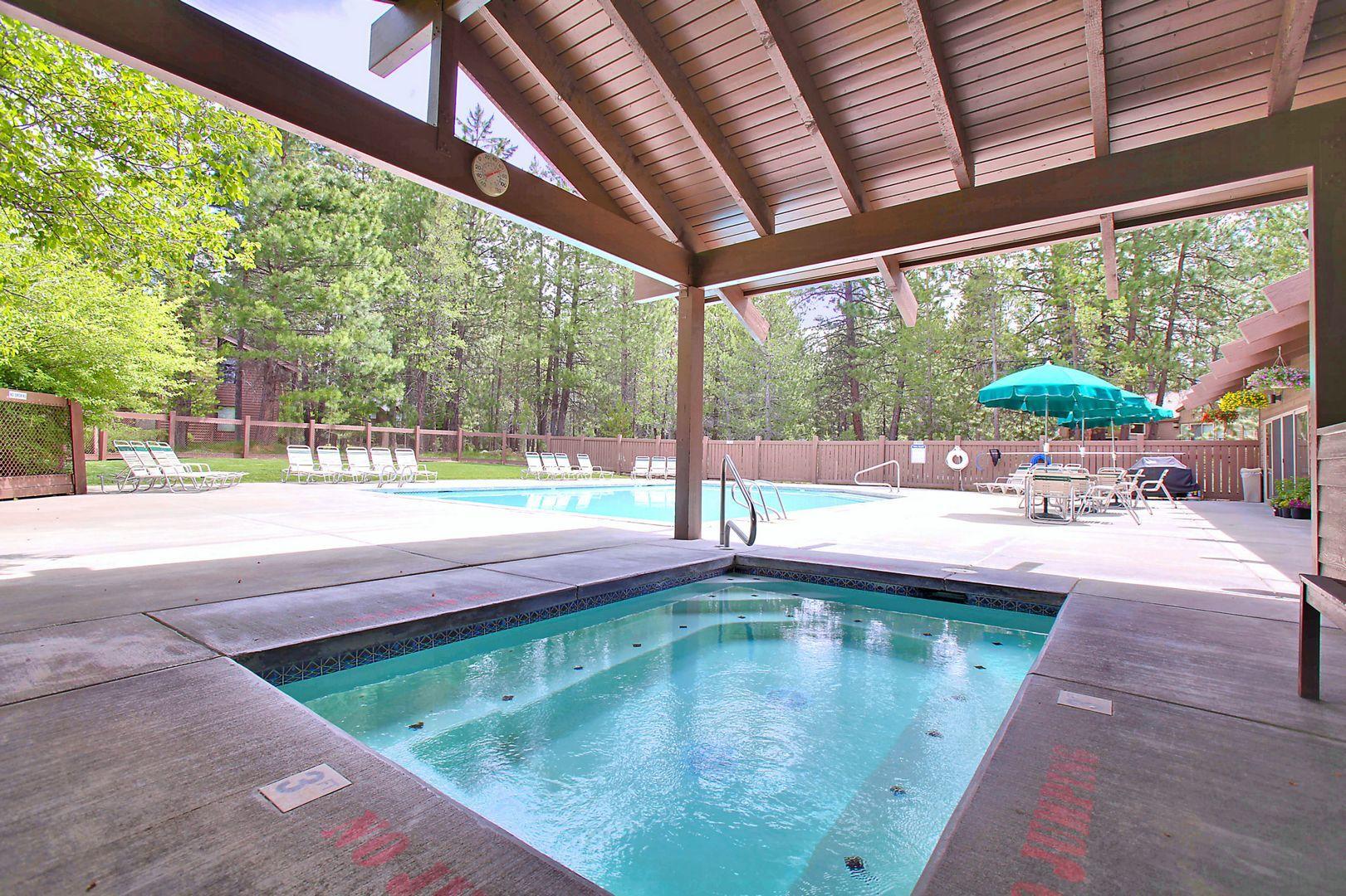 57301 Beaver Ridge Loop, Unit 10 Sunriver, OR 97707 - Photo 21 of 23 a swimming pool with lawn chairs and couches