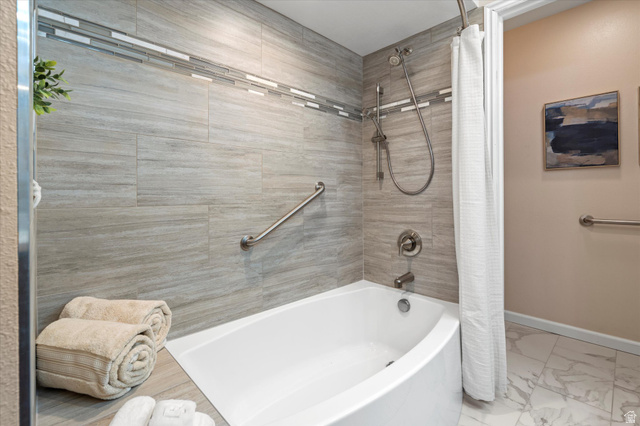 888 East 6895 South Midvale, UT 84047 - Photo 15 of 54 Stylish tub and shower combination with tile surround and contemporary finishes, offering a clean and functional space.