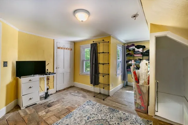 a view of a livingroom with workspace and a flat screen tv