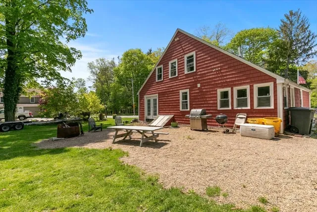 a view of a house with a patio and a garden