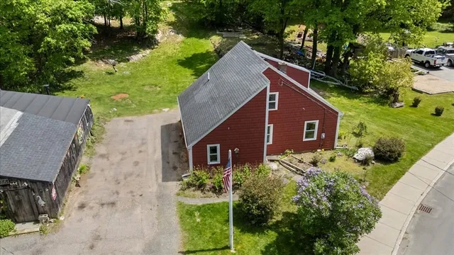 a aerial view of a house with a yard and potted plants