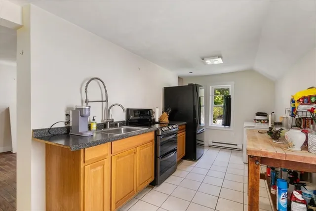 a kitchen with stainless steel appliances granite countertop a sink a stove and refrigerator