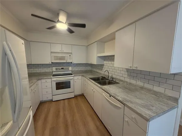 a kitchen with a sink stove and refrigerator
