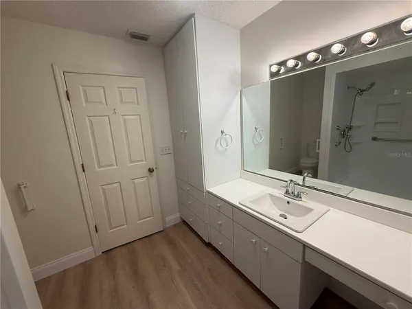 a bathroom with a double vanity sink and mirror