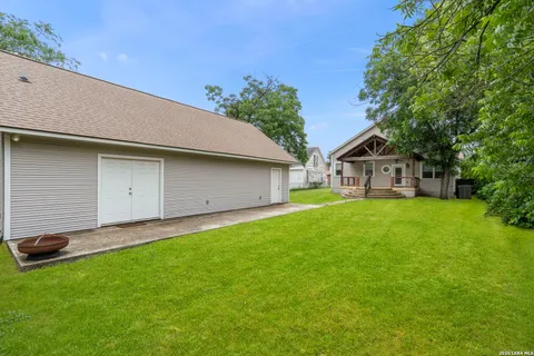 an aerial view of a house with a yard and lake view