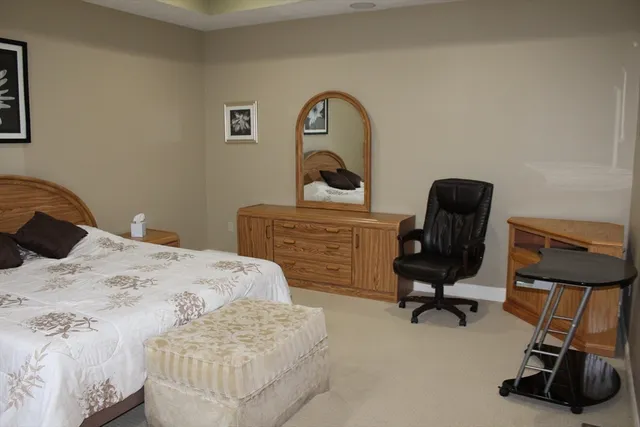 a bedroom with a bed and a chair