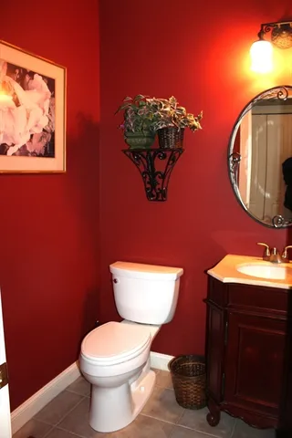 a bathroom with a toilet a sink and mirror