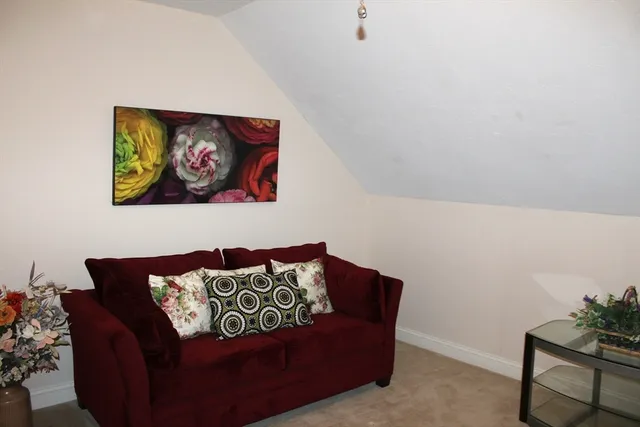 a living room with furniture and wall painting