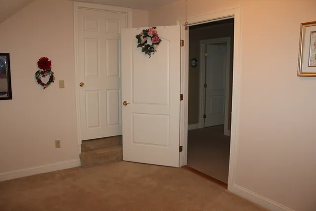 a bathroom with a granite countertop toilet sink and mirror