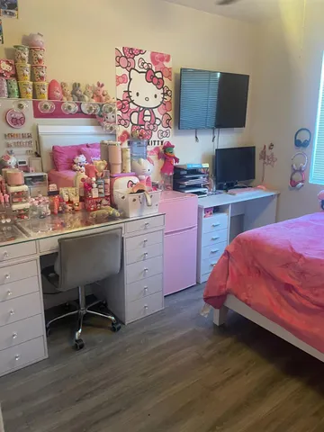 a bedroom with a bed and a desk