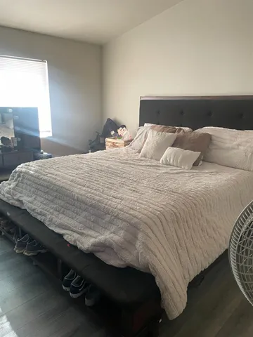 a bedroom with a bed and a night stand