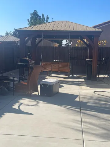 a view of a patio with table and chairs