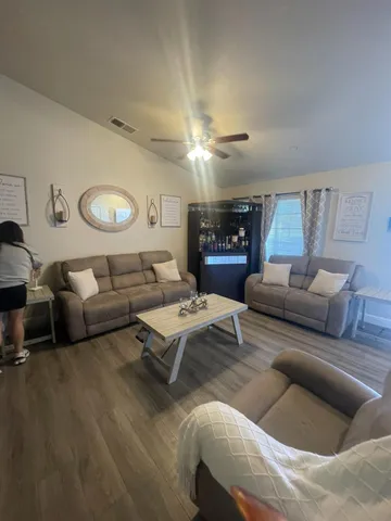 a living room with furniture and a chandelier