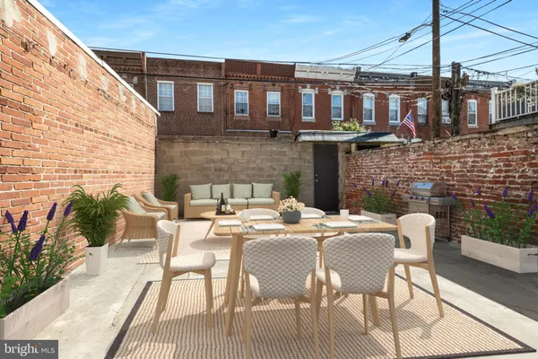 a view of a patio with table and chairs and potted plants