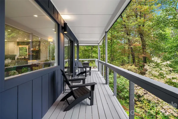 a view of two chairs and a table in a balcony