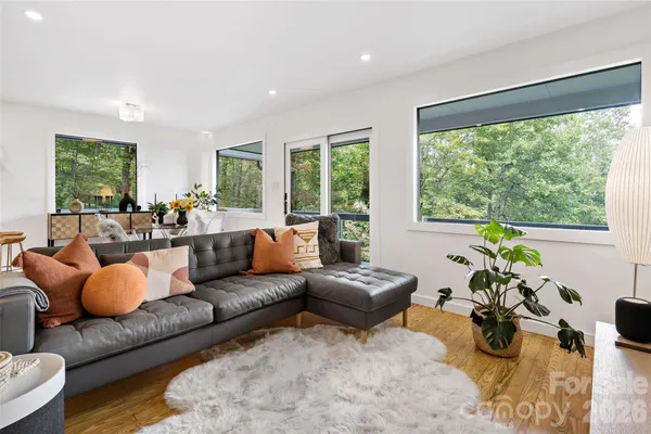 a living room with furniture and a wooden floor
