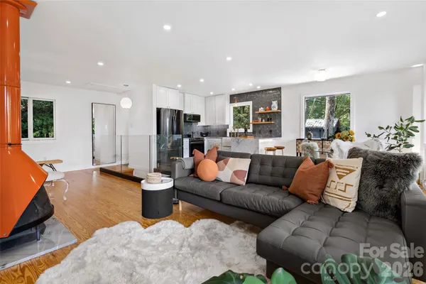 a living room with furniture a large window and a flat screen tv
