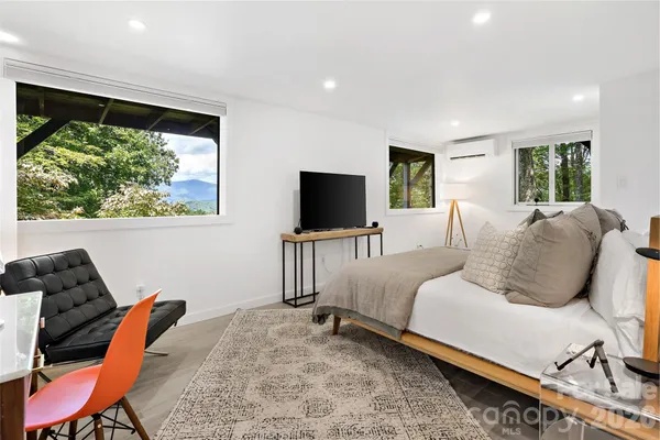 a living room with a flat screen tv and a couch