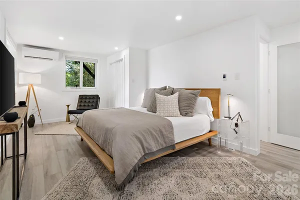 a bedroom with bed and window