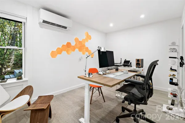 a workspace with furniture and a wooden floor