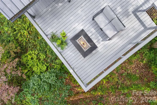 a view of a balcony with a yard