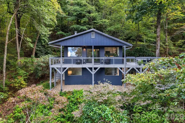 a view of a house with a yard balcony and sitting area