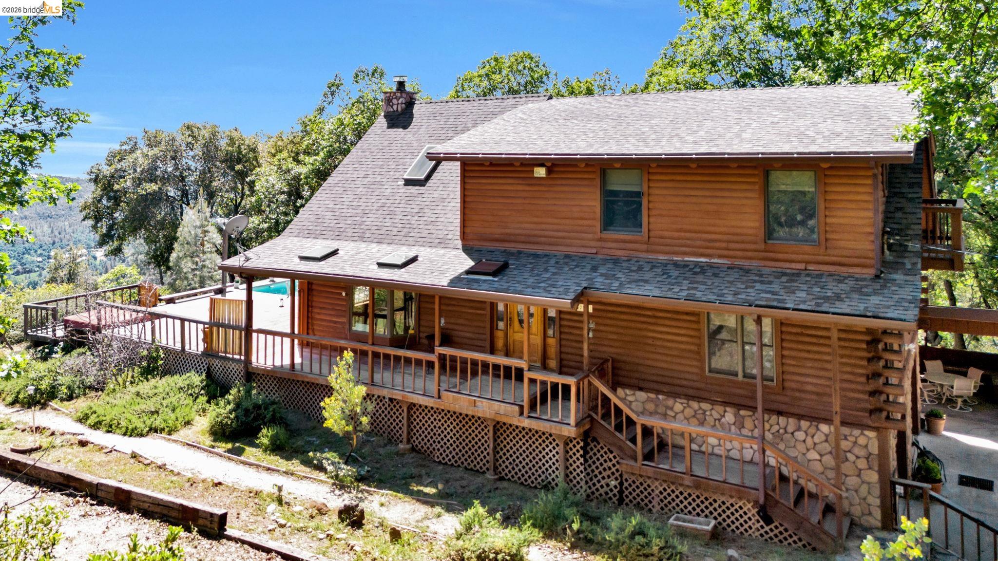 14799 Big Hill Road Sonora, CA 95370 - Photo 6 of 60 Back of property with a deck, a shingled roof, a chimney, and stone siding