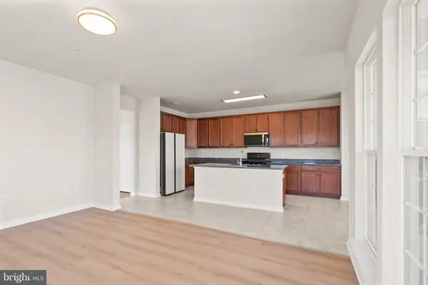 a kitchen with stainless steel appliances granite countertop a refrigerator sink and cabinets