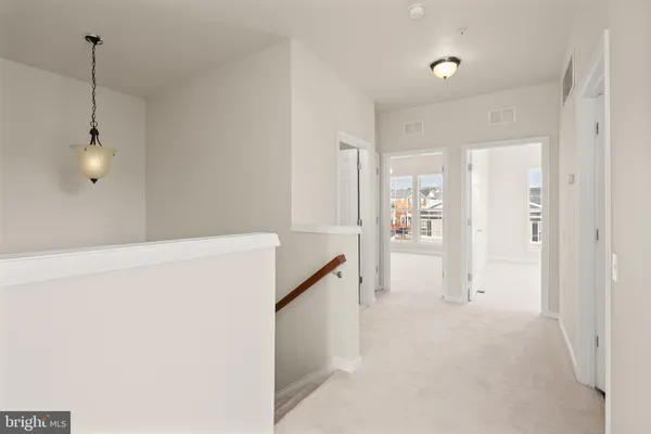 a view of hallway with wooden floor