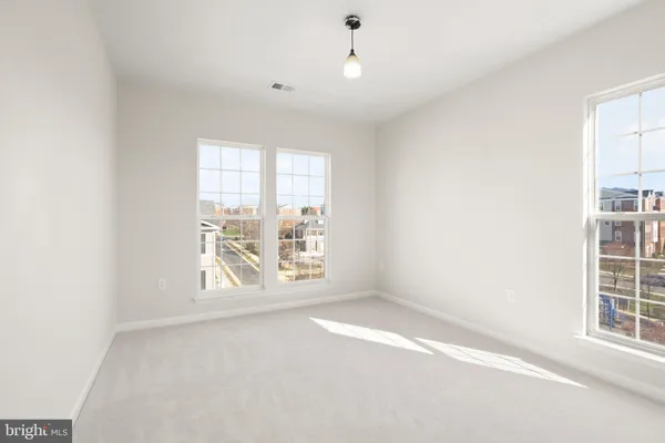 an empty room with windows and entrance