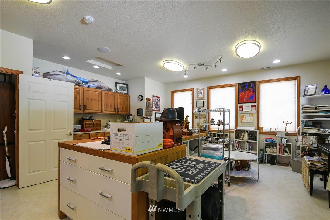 838 Lookout Road Castle Rock, WA 98611 - Photo 22 of 40 a kitchen with stainless steel appliances granite countertop a stove refrigerator and couches with wooden floor
