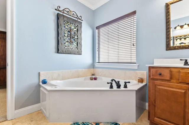a bathroom with a granite countertop sink mirror vanity and toilet