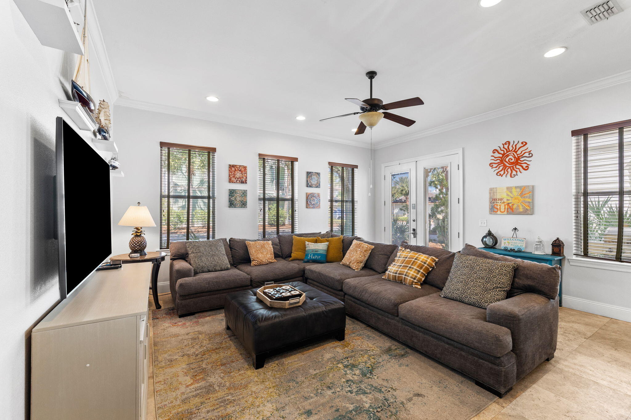 211 Grand Key Loop East Destin, FL 32541 - Photo 4 of 28 a living room with furniture ceiling fan and a flat screen tv