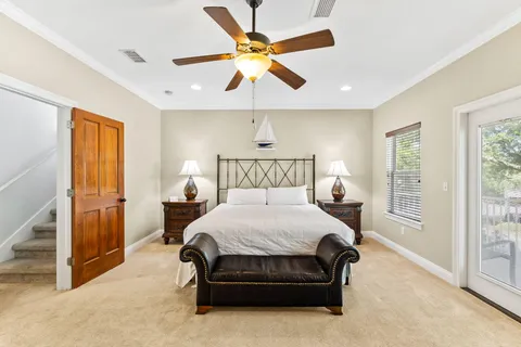 a bed room with a bed and a ceiling fan