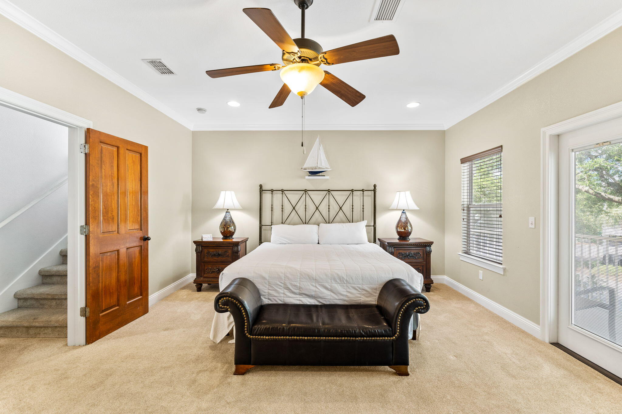 211 Grand Key Loop East Destin, FL 32541 - Photo 9 of 28 a bed room with a bed and a ceiling fan