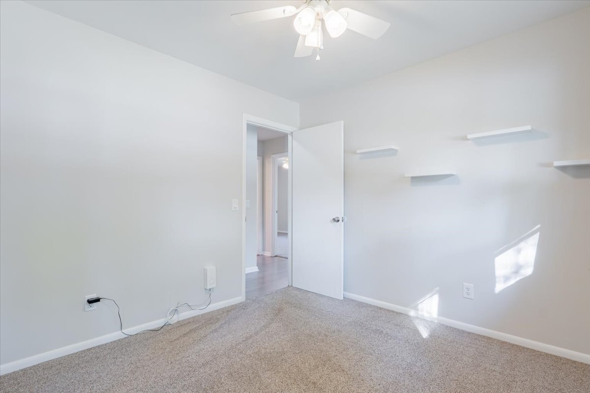 305 Highpoint Road Normal, IL 61761 - Photo 12 of 29 an empty room with a chandelier fan and windows