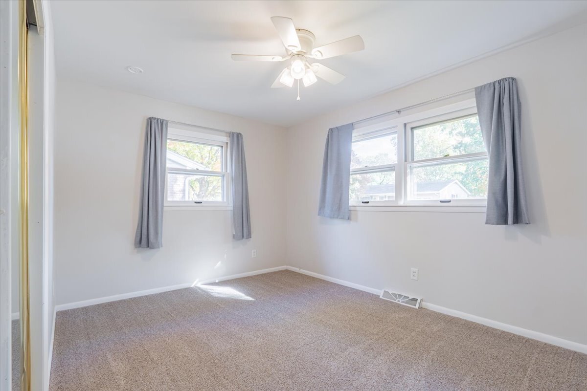 305 Highpoint Road Normal, IL 61761 - Photo 13 of 29 an empty room with windows and chandelier fan