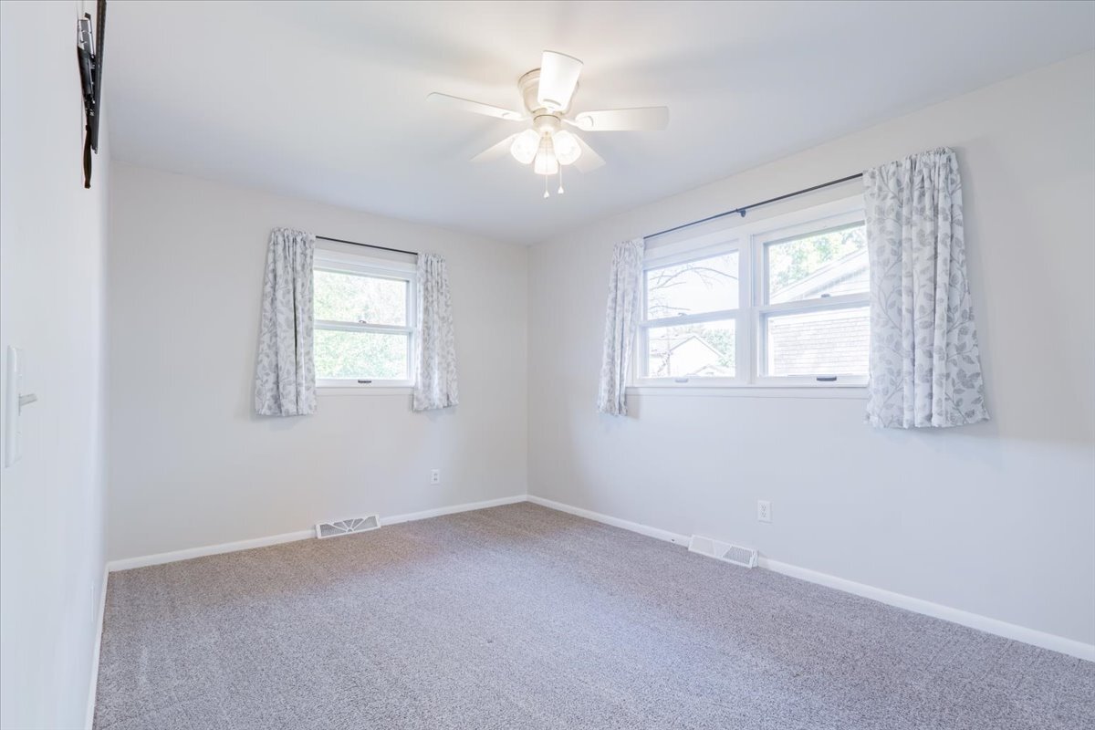 305 Highpoint Road Normal, IL 61761 - Photo 15 of 29 an empty room with windows and chandelier fan