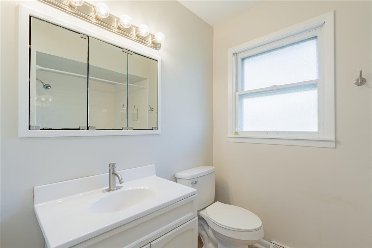 305 Highpoint Road Normal, IL 61761 - Photo 17 of 29 a bathroom with a sink a toilet and mirror