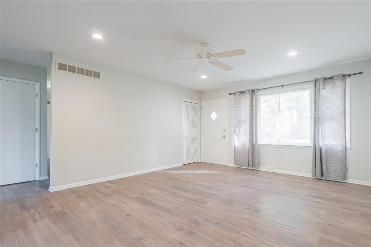 305 Highpoint Road Normal, IL 61761 - Photo 5 of 29 a view of an empty room with wooden floor and a window