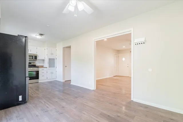 a view of a kitchen with refrigerator and an oven