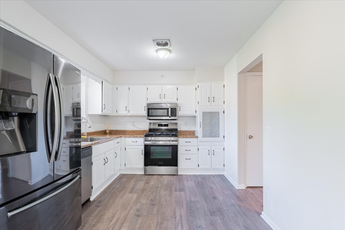 305 Highpoint Road Normal, IL 61761 - Photo 8 of 29 a kitchen with granite countertop a refrigerator stove top oven and sink
